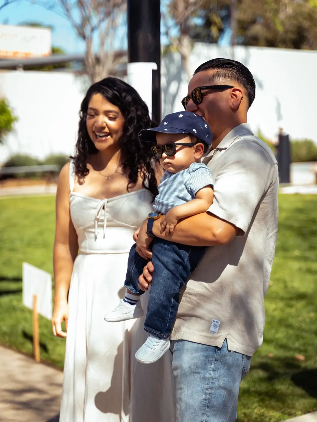 A family smiling together at an outdoor gathering