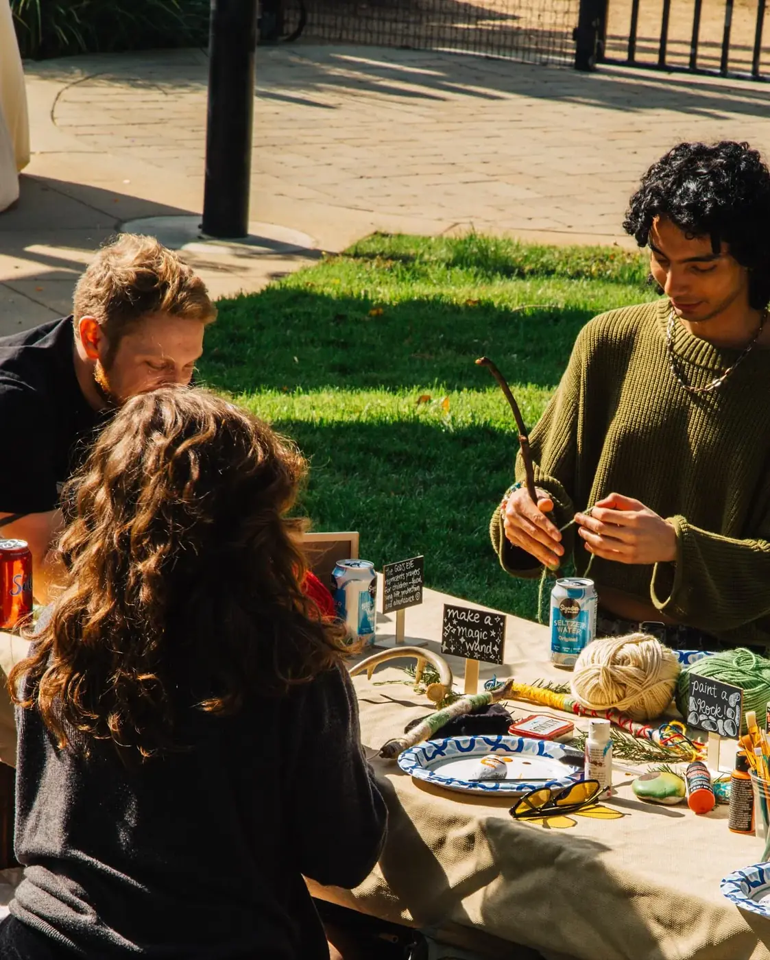 Community members sharing food and conversation on the grass